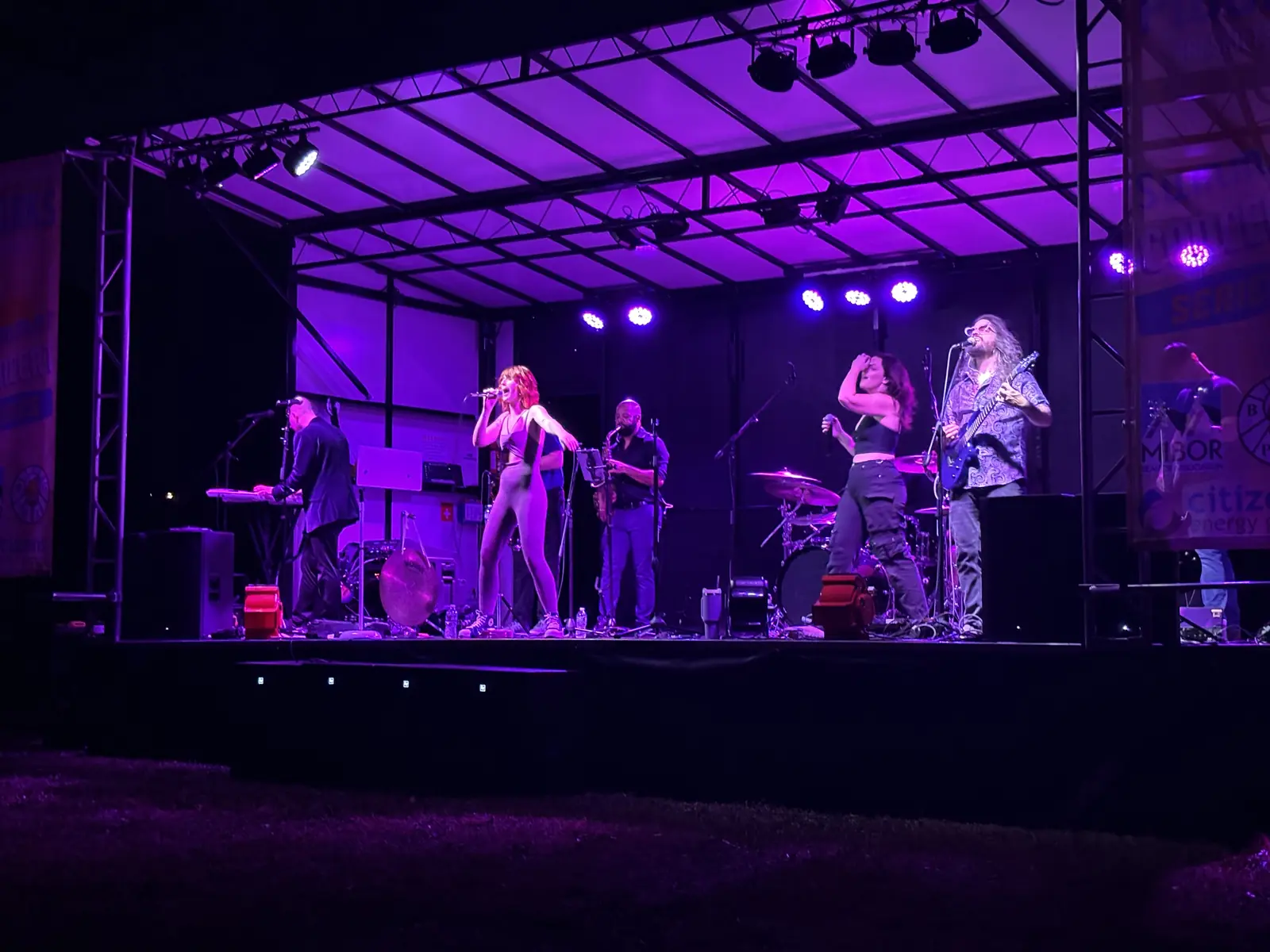 Band performing under the stage's overhead lighting
